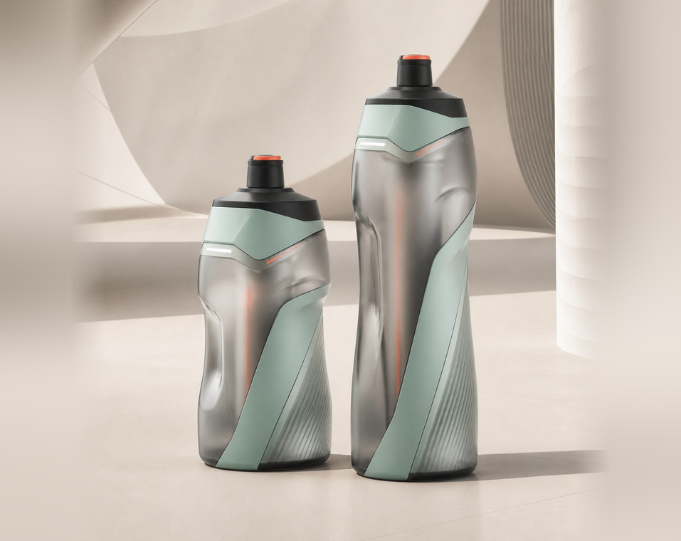 Black performance squeeze bottle with textured grip, orange valve, and connected lid detail.
