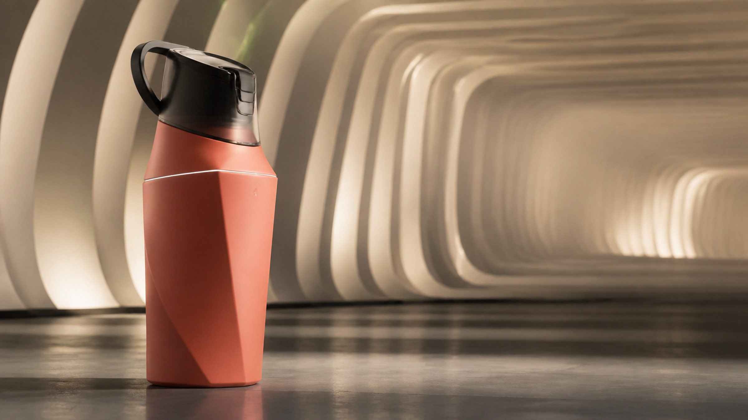 Coral performance tumbler with molded outer shell beside a tennis racket and basketball.